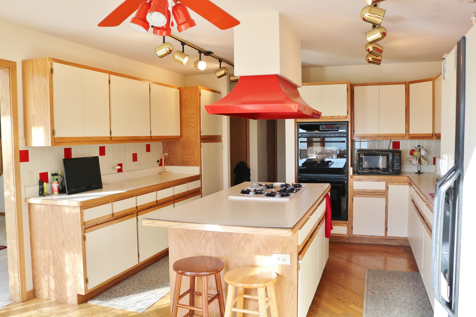 12232 Grove Road Minooka, IL 60447 - Photo 10 of 57 a kitchen with a stove a refrigerator and a dining table