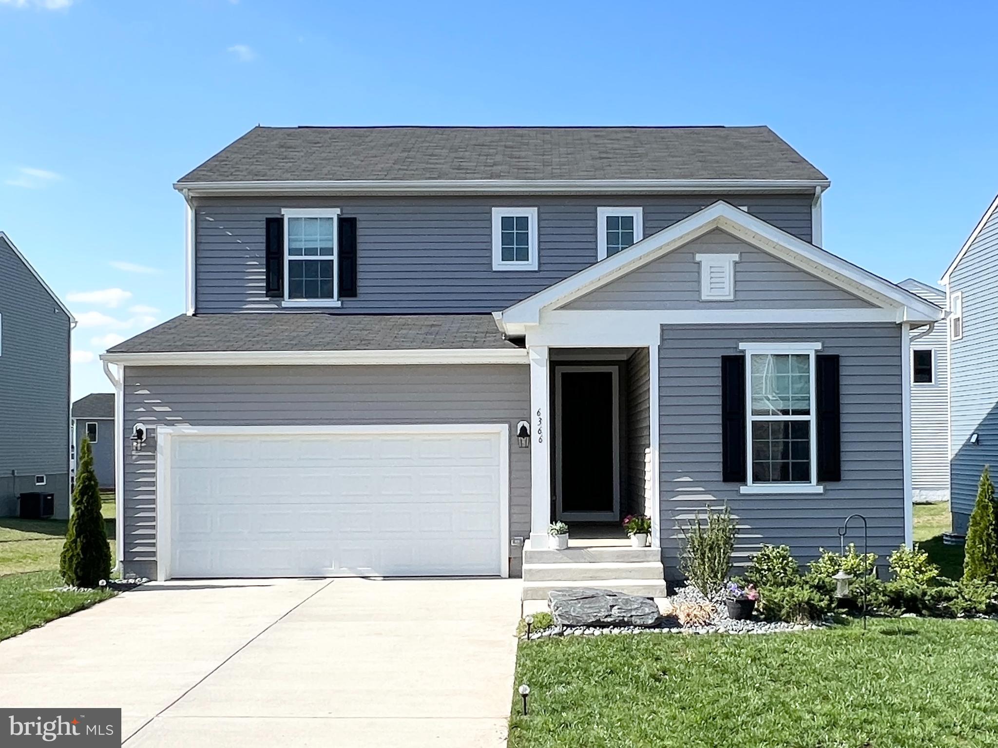 a front view of a house with yard