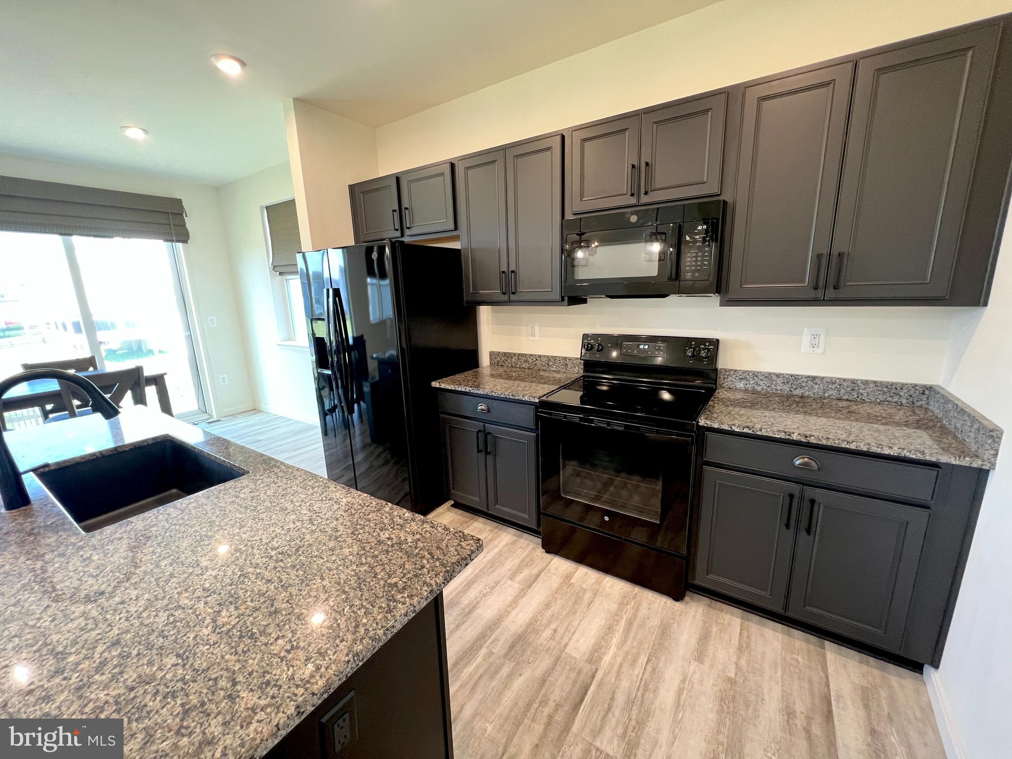 6366 Pointer Lane King George, VA 22485 - Photo 12 of 48 a kitchen with granite countertop wooden cabinets and stainless steel appliances