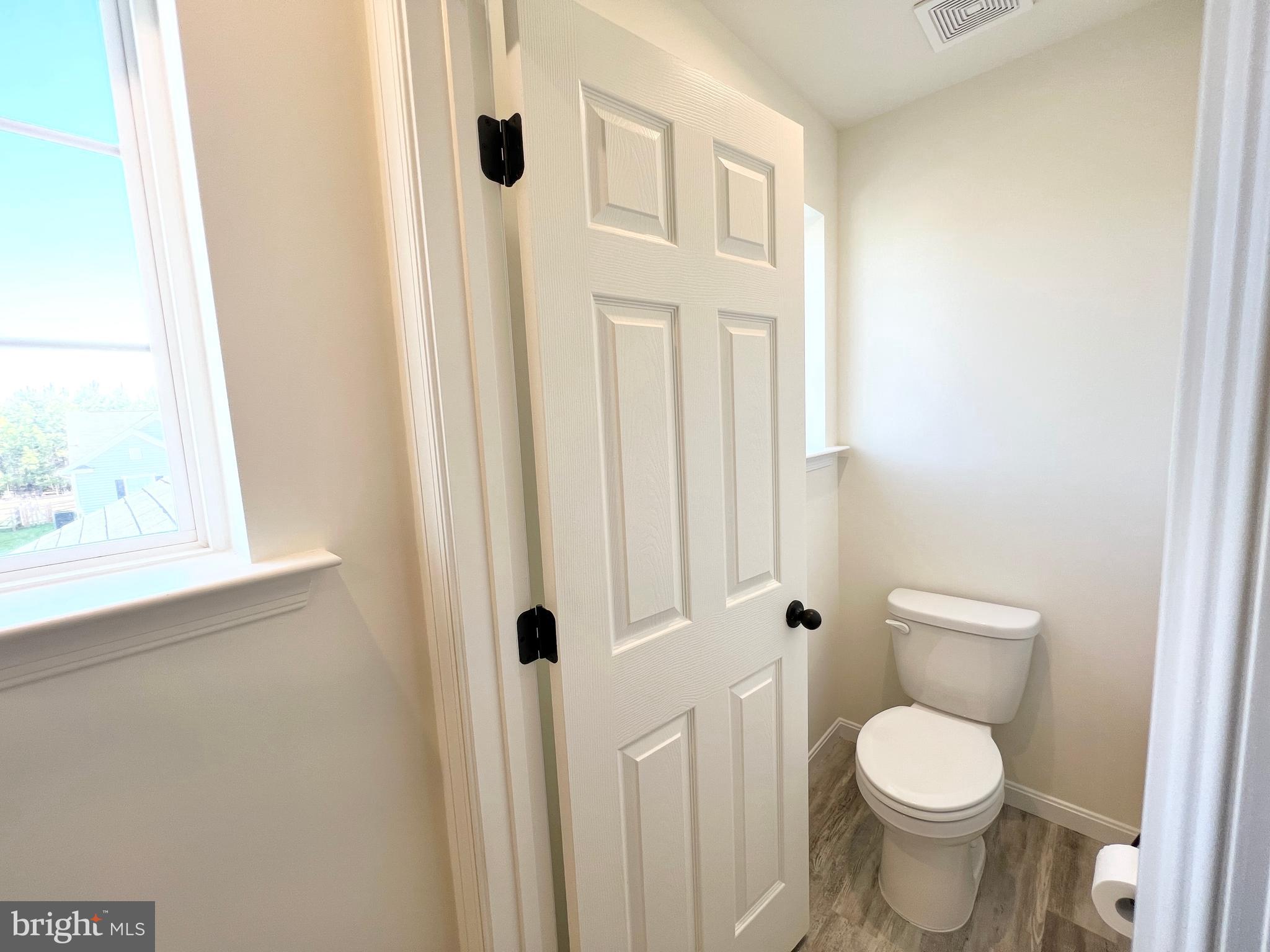 6366 Pointer Lane King George, VA 22485 - Photo 26 of 48 a white toilet sitting next to a bathroom sink