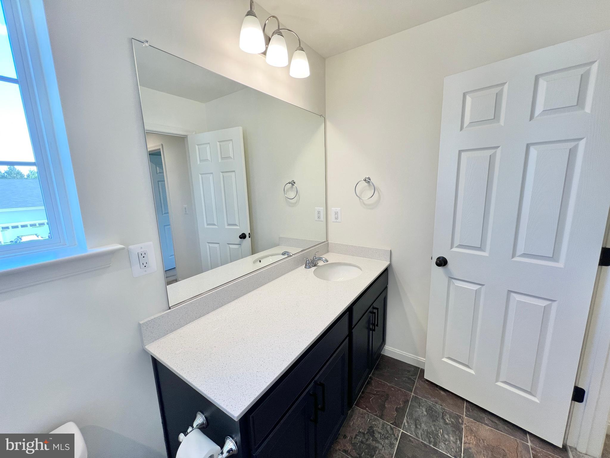 6366 Pointer Lane King George, VA 22485 - Photo 30 of 48 a bathroom with a sink a mirror and a shower