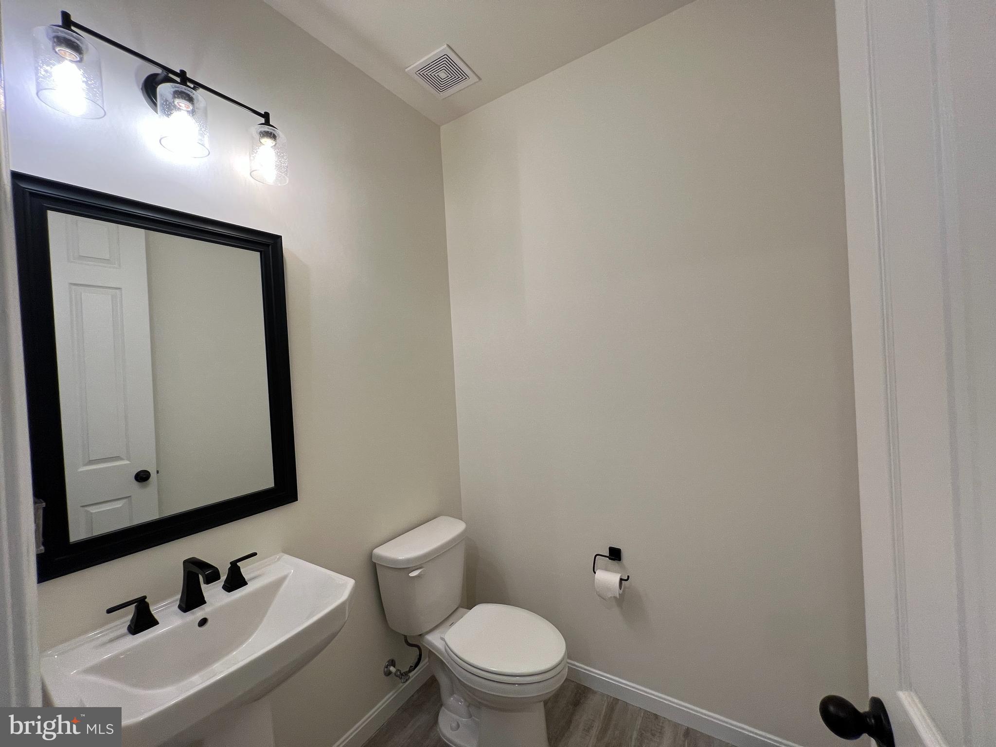 6366 Pointer Lane King George, VA 22485 - Photo 8 of 48 a bathroom with a toilet sink and mirror
