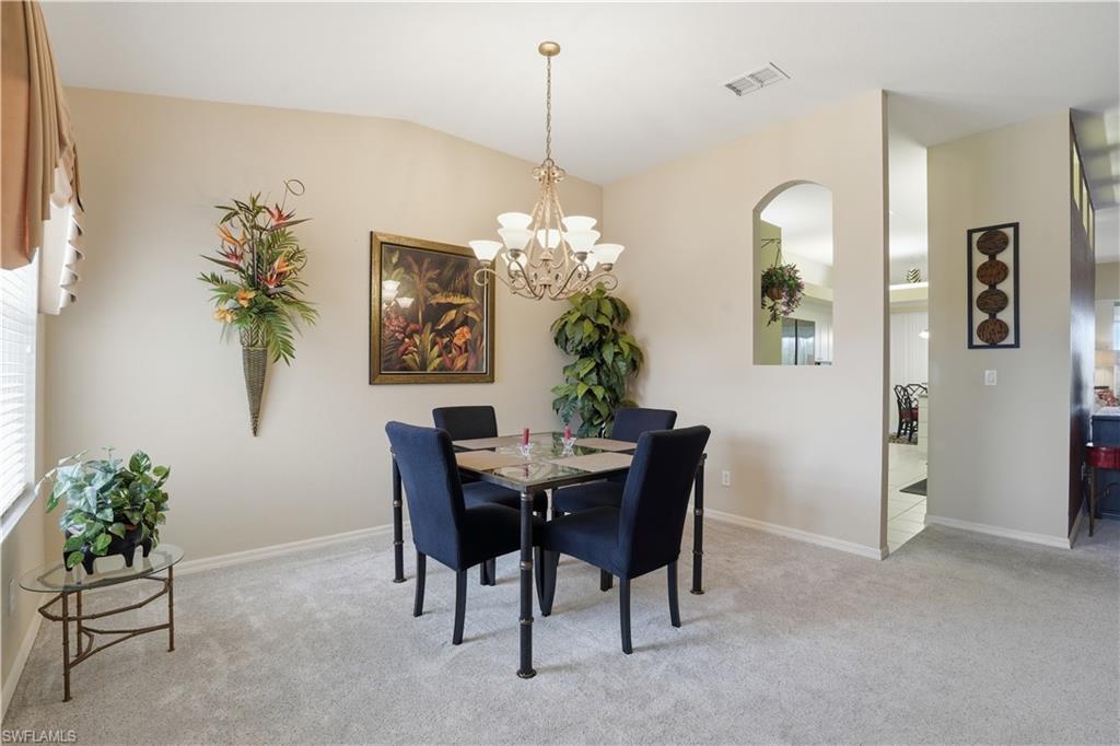 10871 Crooked River Road, Unit 202 Estero, FL 34135 - Photo 8 of 46 a dining room with furniture and window