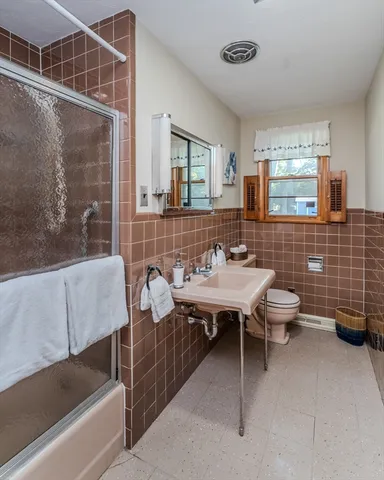 a bathroom with a sink mirror and a bathtub