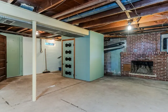 a view of an empty room with a fireplace