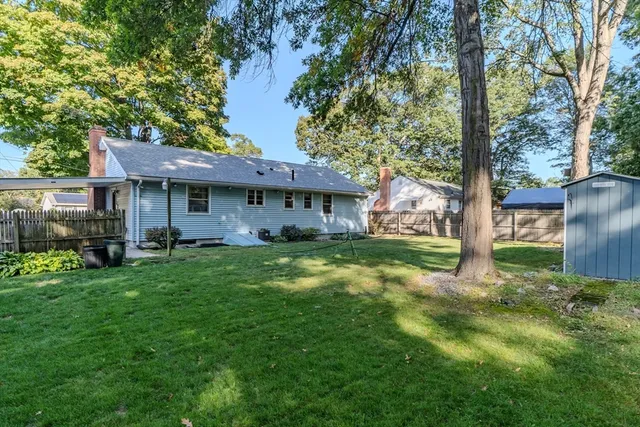 a view of a house with a yard and sitting area