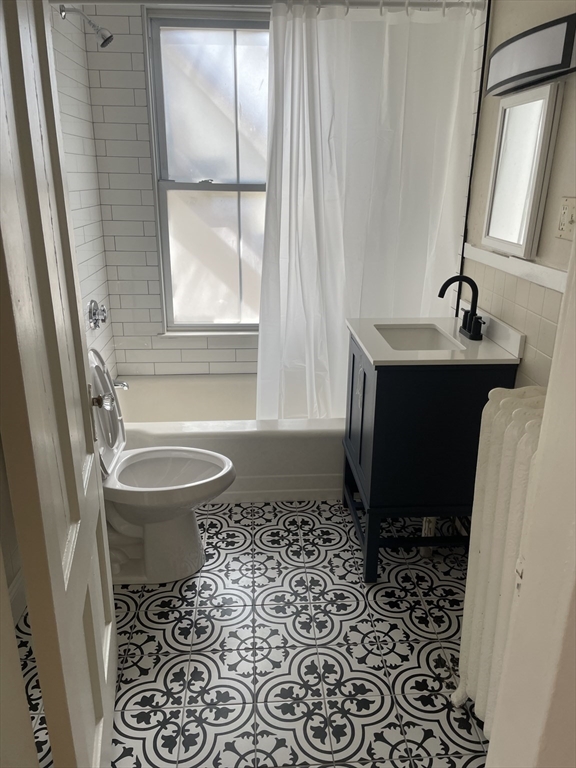 15 Harris Street, Unit 2 Marblehead, MA 01945 - Photo 2 of 12 a bathroom with a sink toilet and shower