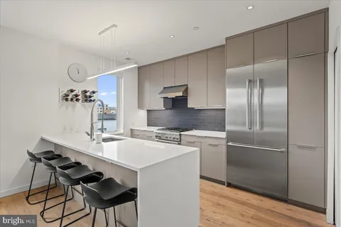 a kitchen with a sink stove and refrigerator
