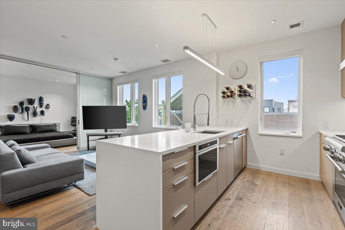 1932 9th Street Northwest, Unit 402 Washington, DC 20001 - Photo 13 of 42 a view of kitchen with stainless steel appliances granite countertop a stove and a sink