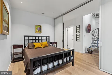 a living room with furniture and paintings on the wall