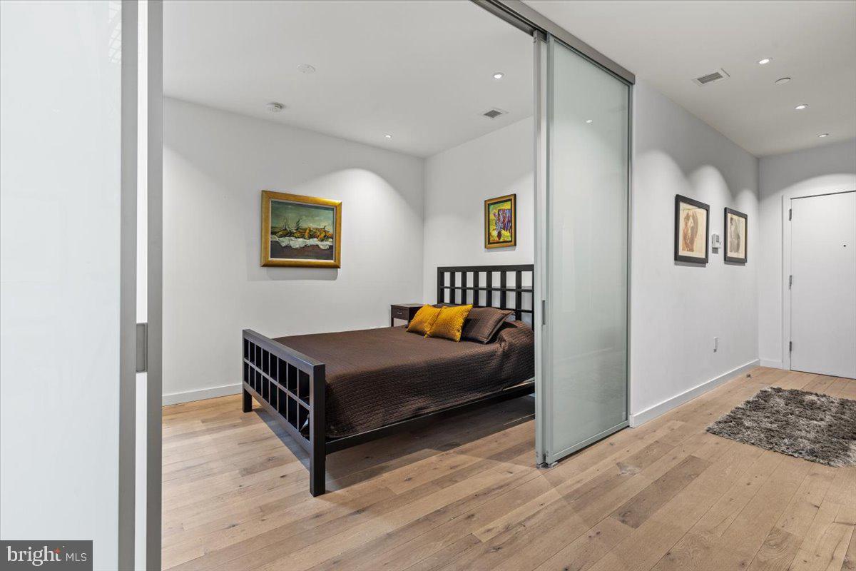 1932 9th Street Northwest, Unit 402 Washington, DC 20001 - Photo 32 of 42 a living room with furniture and paintings on the wall