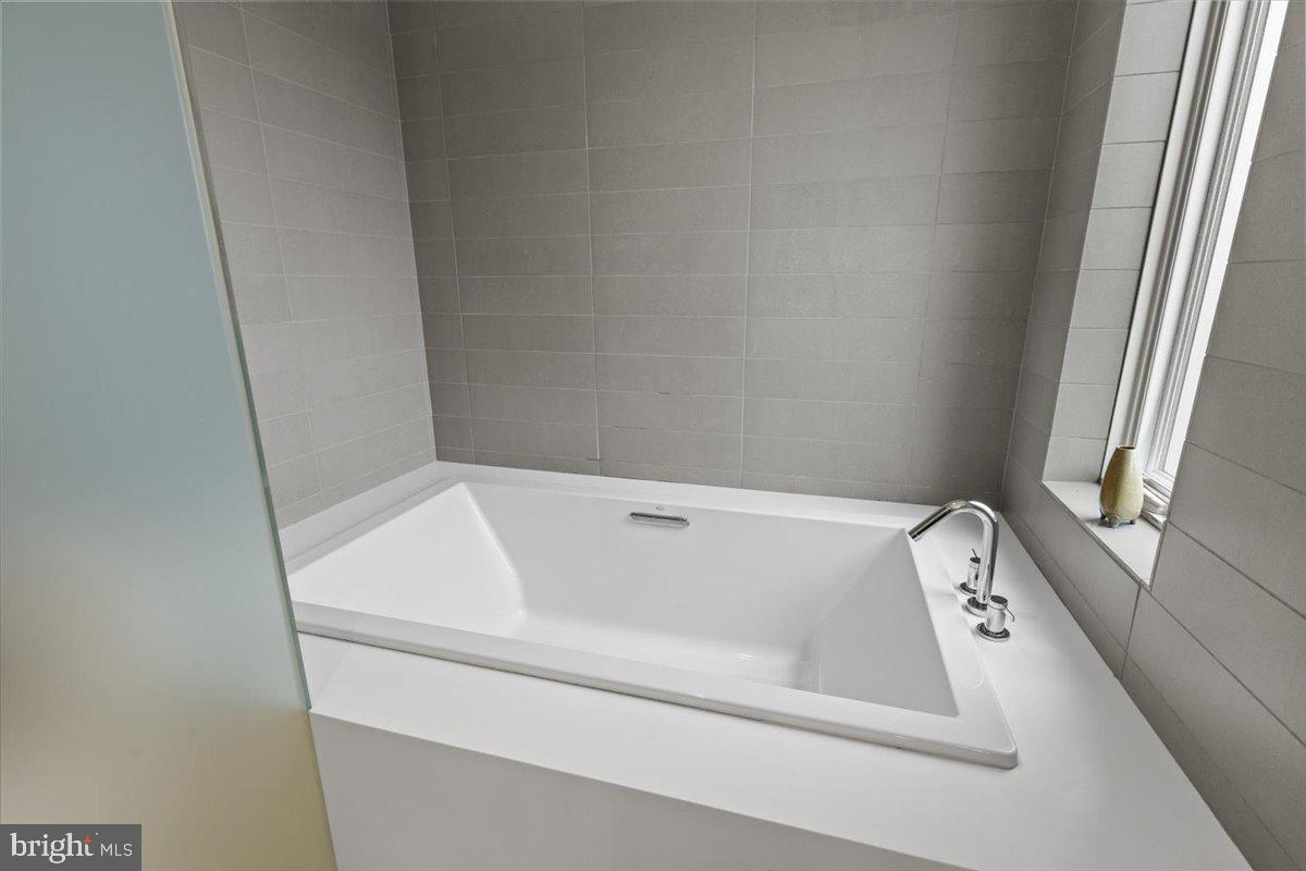 1932 9th Street Northwest, Unit 402 Washington, DC 20001 - Photo 34 of 42 a bathroom with a bathtub