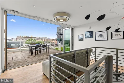 a room with a couch and painting on the wall