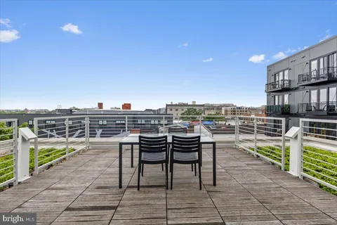 a view of a balcony with wooden floor and city view