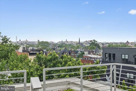 a view of a hallway with wooden floor and entryway