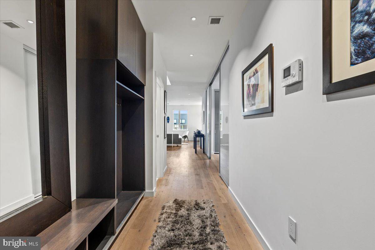 1932 9th Street Northwest, Unit 402 Washington, DC 20001 - Photo 4 of 42 a view of a hallway with wooden floor and staircase
