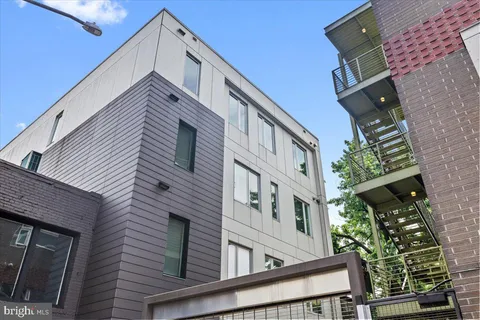 a view of a white building with many windows