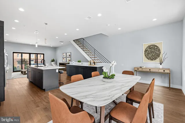 a kitchen with a wooden table and chairs