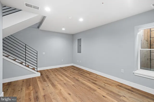 a view of a room with wooden floor and windows