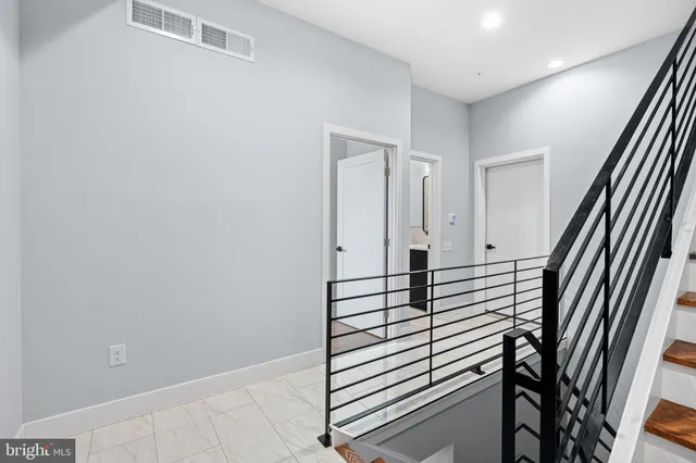 a view of a hallway with paintings on the wall