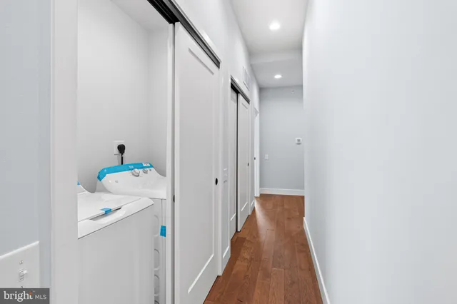 a view of hallway with wooden floor