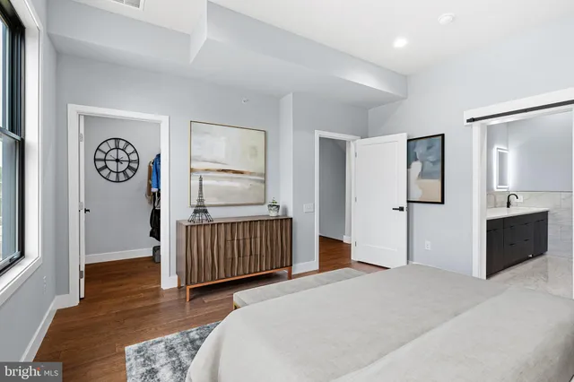 a bedroom with a bed and a view of kitchen