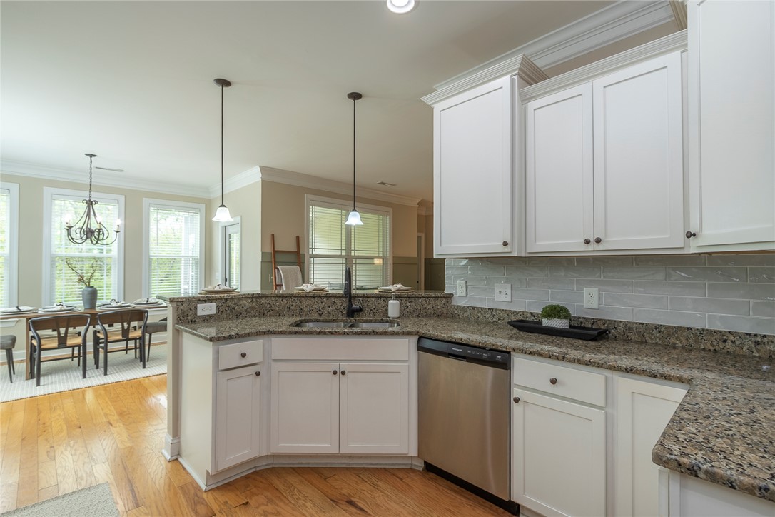 234 Streams Way Anderson, SC 29625 - Photo 32 of 44 This kitchen and dining area features rich hardwood floors and an open concept layout.