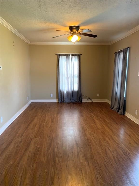 5534 Lexington Road Corpus Christi, TX 78412 - Photo 2 of 7 an empty room with wooden floor and windows