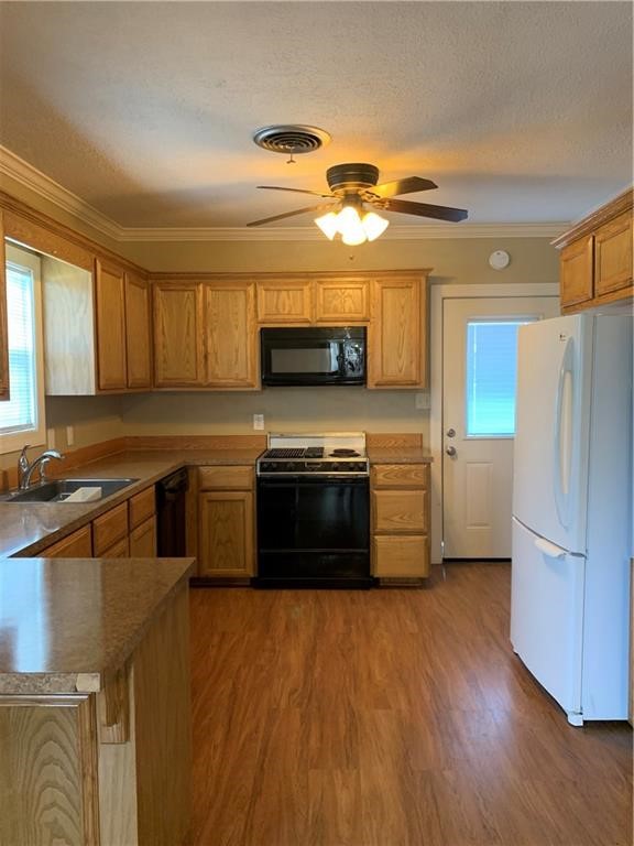 5534 Lexington Road Corpus Christi, TX 78412 - Photo 3 of 7 a kitchen with stainless steel appliances granite countertop a stove a sink and a refrigerator