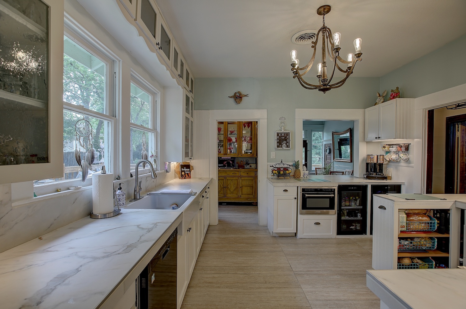 1903 South Austin Avenue Georgetown, TX 78626 - Photo 8 of 40 Updated with sleek appliances, and lovely tile counters and floors. Glass front cabinets with pebble glass show off your pretties, with many lower cabinets to make the kitchen useful and efficient