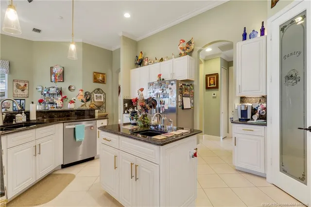 a view of a dining room and livingroom with furniture wooden floor a chandelier