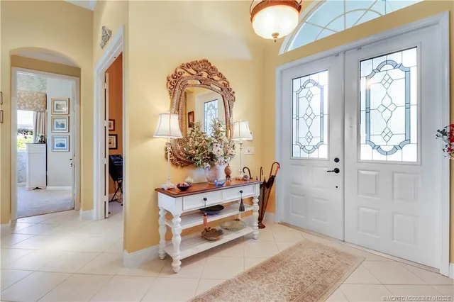 a dining room with furniture and chandelier