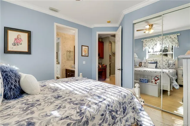 a front view of a house with a yard and palm trees