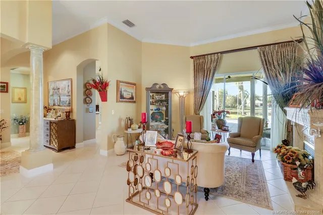 a living room with furniture and a chandelier