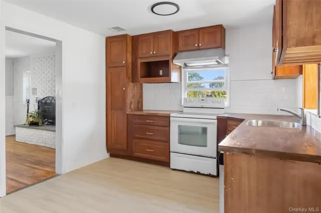 a kitchen with stainless steel appliances a stove a microwave and cabinets