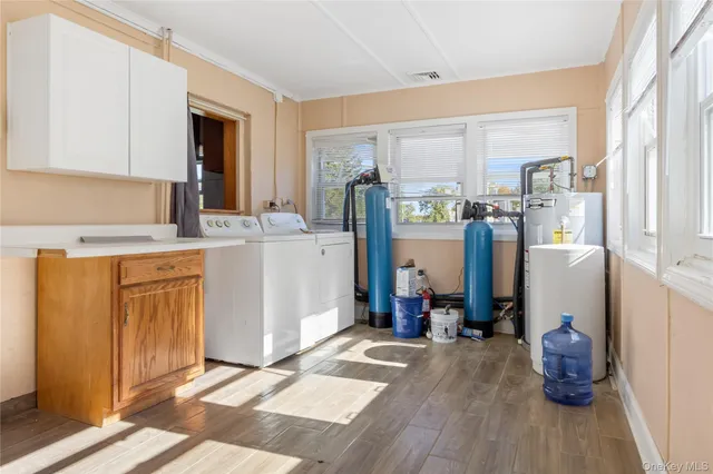 a view of a kitchen with fridge and wooden floor