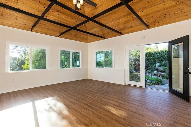 a view of a room with wooden floor and windows