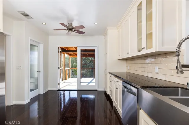 a kitchen with a stove oven and white cabinets