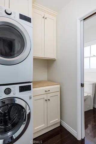 a kitchen with stainless steel appliances granite countertop a refrigerator a sink dishwasher a stove and white countertops with wooden floor