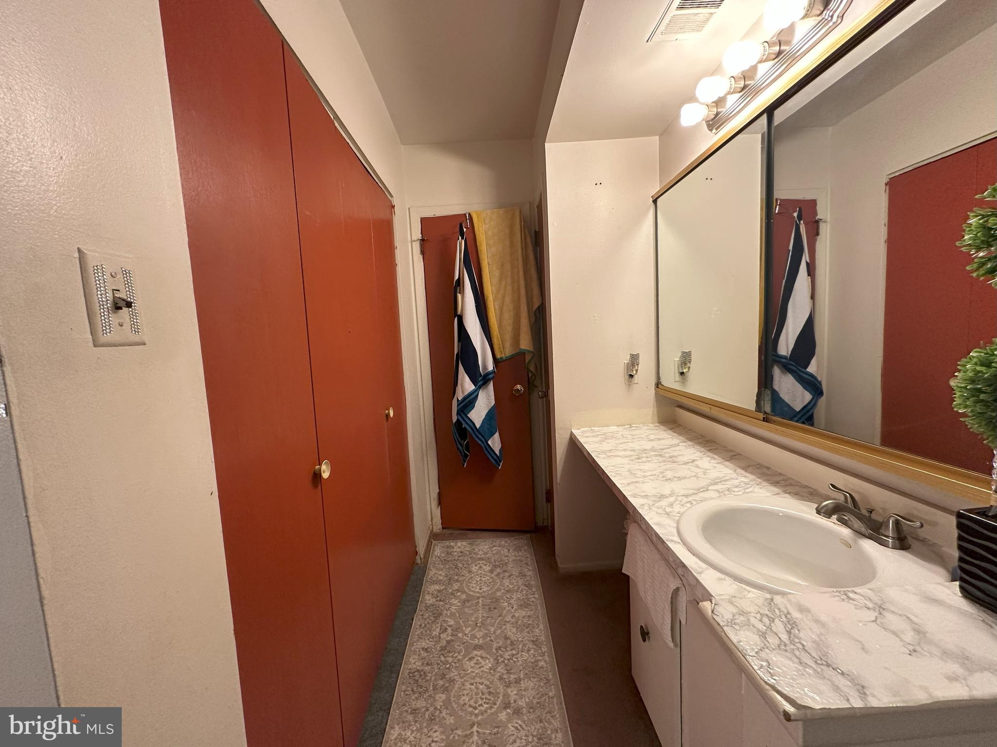 7525 Calvert Street Philadelphia, PA 19152 - Photo 15 of 38 a bathroom with a granite countertop sink a washer and dryer
