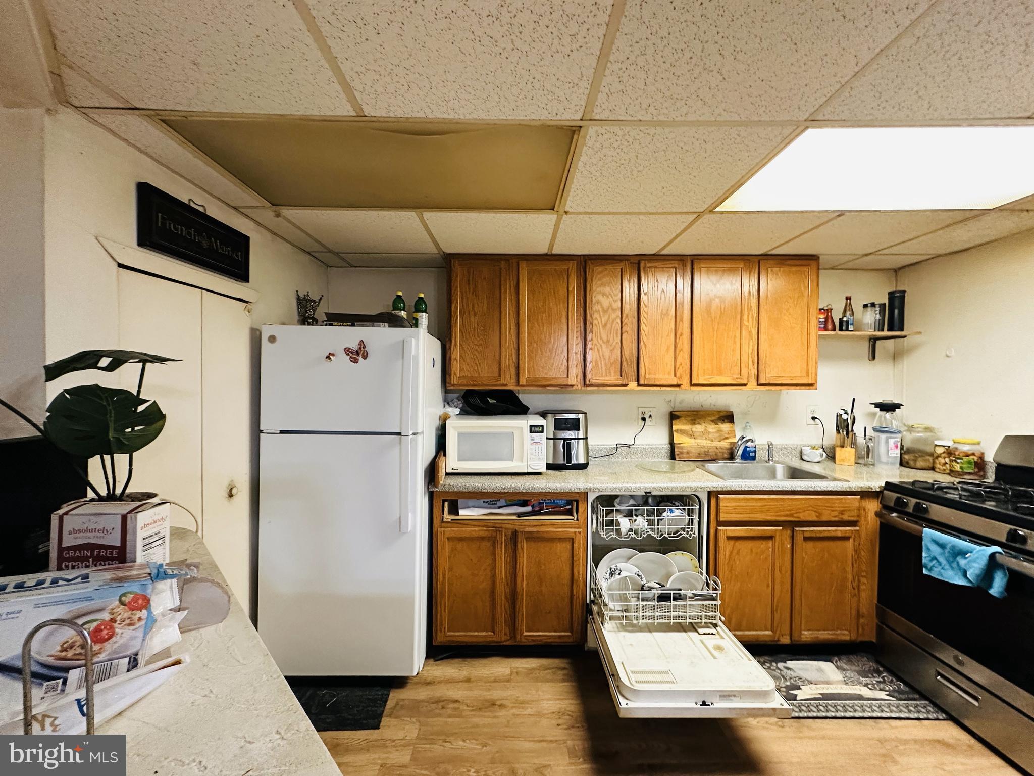 7525 Calvert Street Philadelphia, PA 19152 - Photo 28 of 38 a kitchen with a sink a stove and a refrigerator
