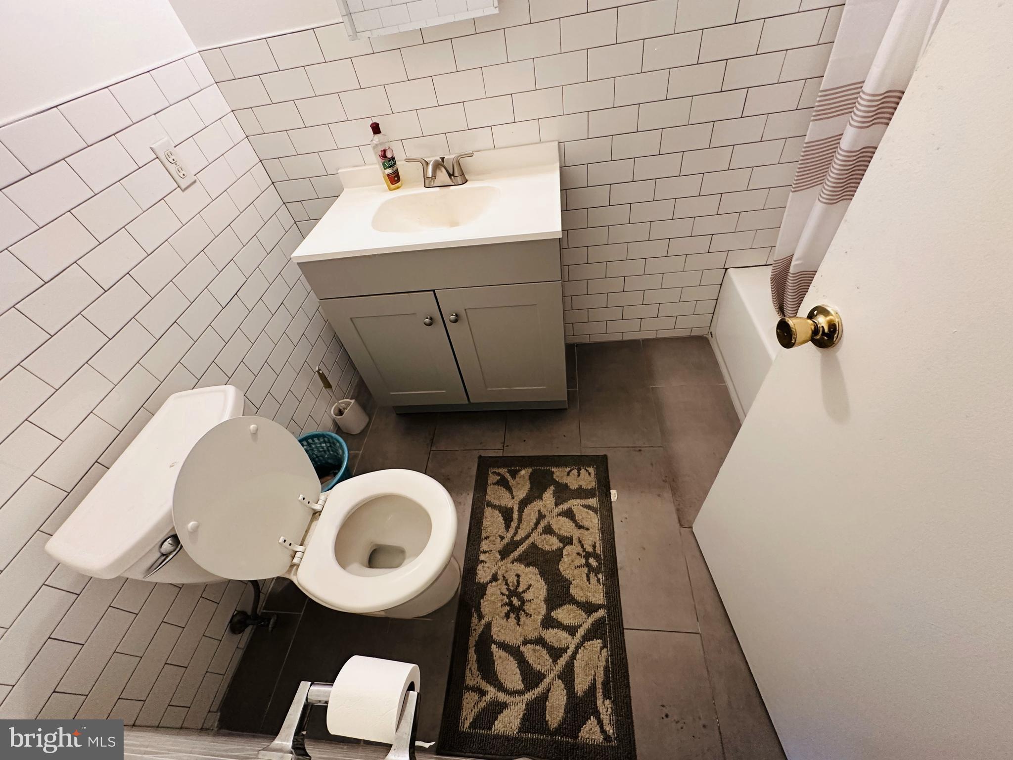 7525 Calvert Street Philadelphia, PA 19152 - Photo 31 of 38 a bathroom with a sink mirror vanity and toilet