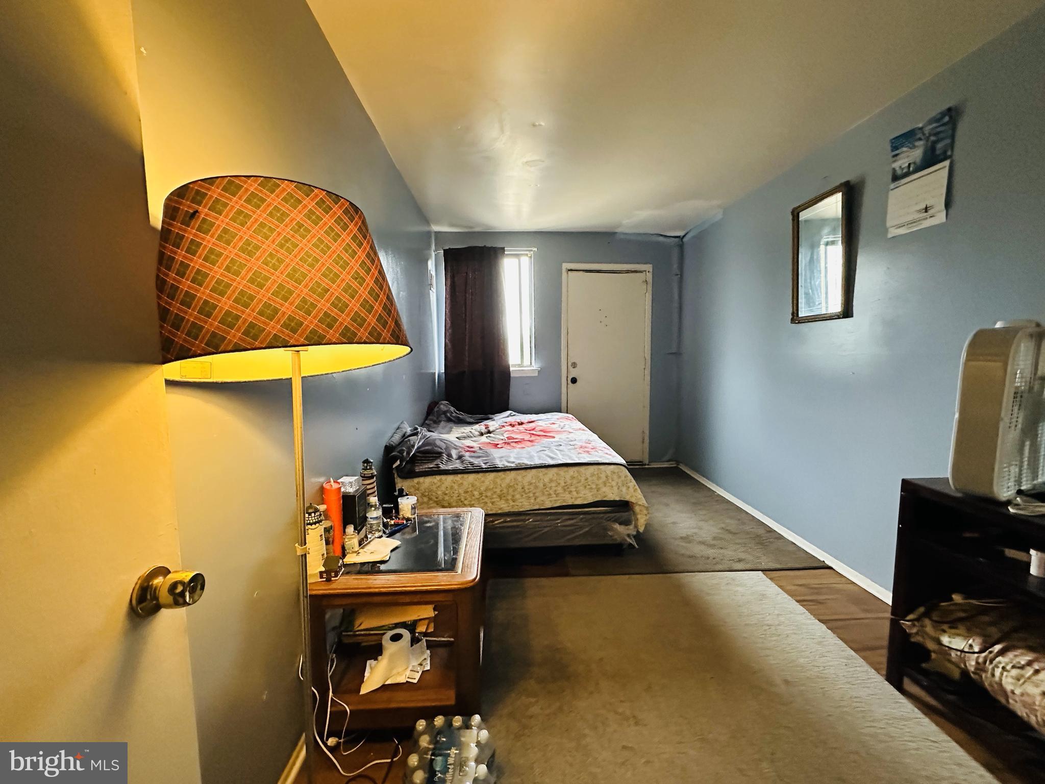 7525 Calvert Street Philadelphia, PA 19152 - Photo 33 of 38 a bedroom with a bed and wooden floor