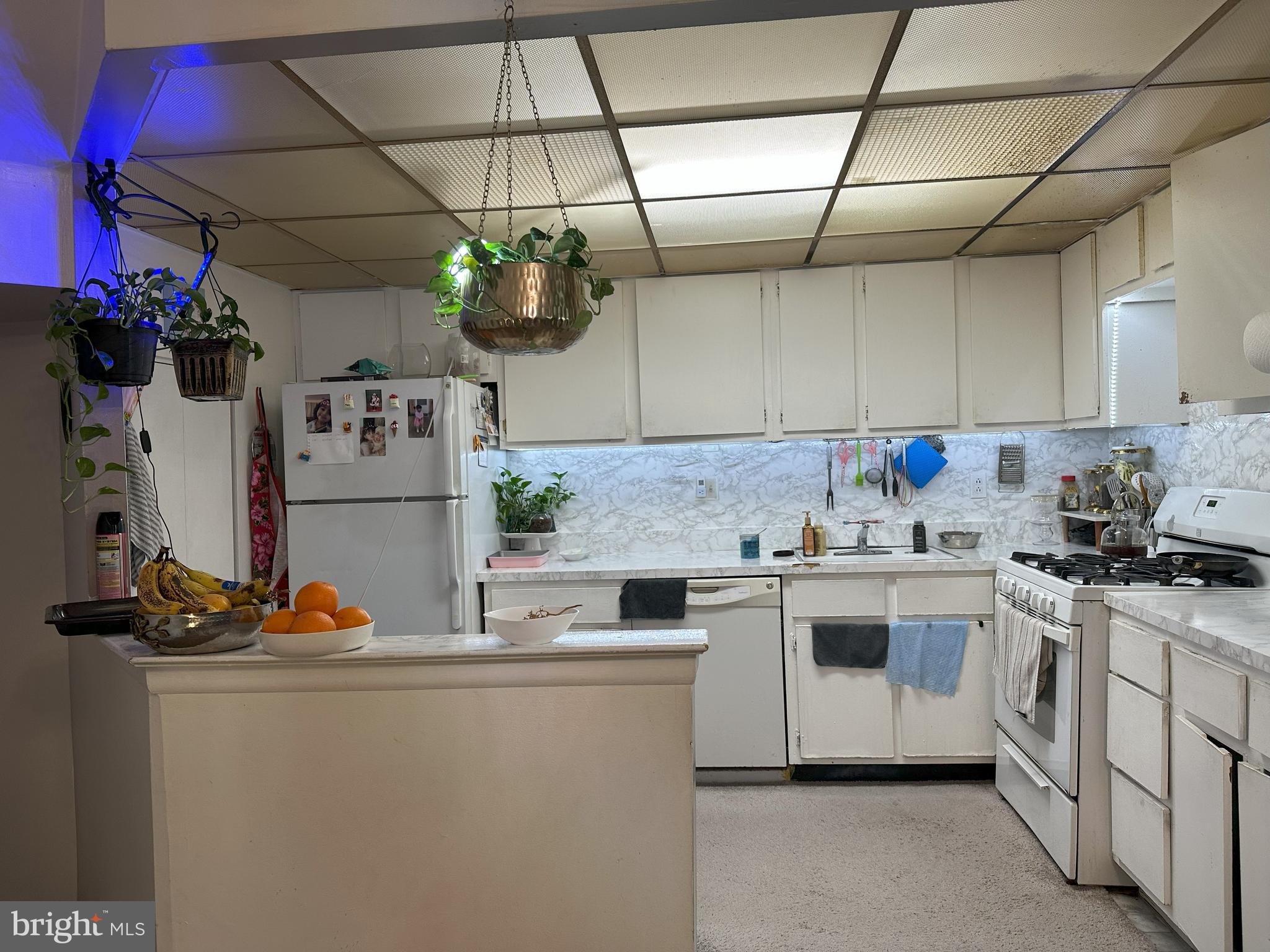 7525 Calvert Street Philadelphia, PA 19152 - Photo 8 of 38 a kitchen with stainless steel appliances granite countertop a sink a stove and refrigerator
