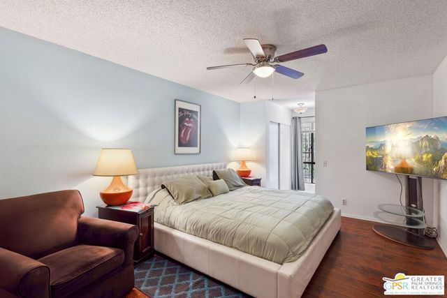 a bedroom with a bed and a lamp