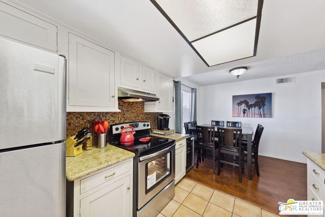 a bedroom with a bed lamp and a mirror