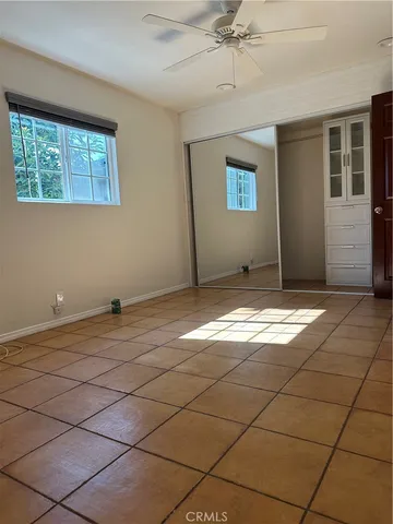 a view of a livingroom with wooden floor and a window