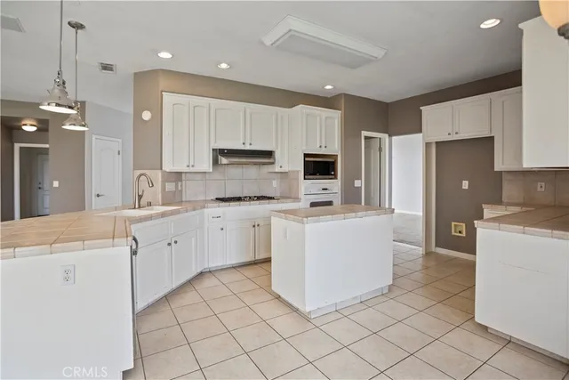 a kitchen with cabinets and white appliances