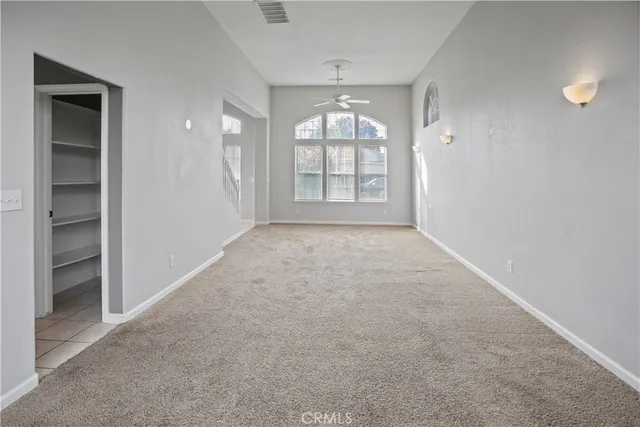 an empty room with windows and closet
