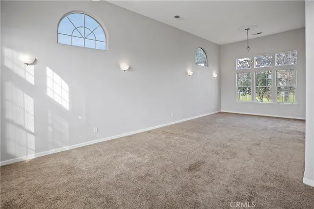 an empty room with windows and outdoor view